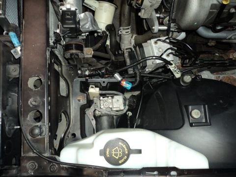 2004 Mercury Grand Marquis - Close-up view of the engine bay, showing the washer fluid reservoir and various engine components.