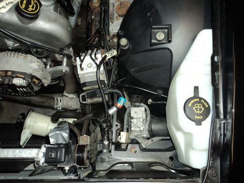 2004 Mercury Grand Marquis - Close-up view of engine bay components including the ABS module and washer fluid reservoir.