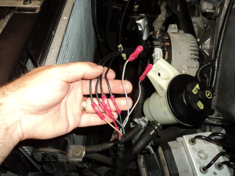 2004 Mercury Grand Marquis - Wiring connections being made near engine components, likely for an electrical modification.