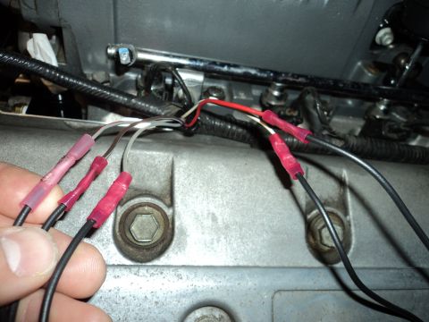2004 Mercury Grand Marquis - Splicing wires on an engine component, likely for an electrical modification.