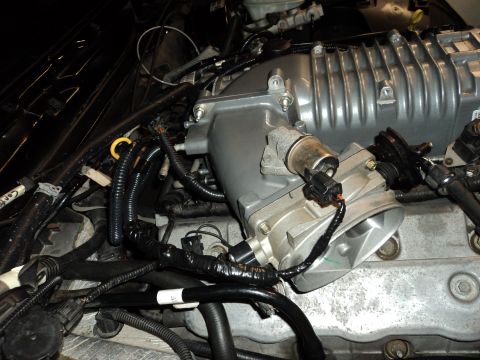 2004 Mercury Grand Marquis - Close-up view of a supercharger and intake manifold installed in an engine bay.