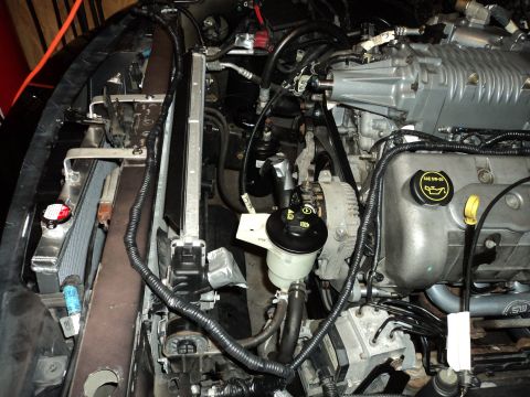 2004 Mercury Grand Marquis - Close-up view of a modified engine bay, showing a supercharger and radiator assembly.