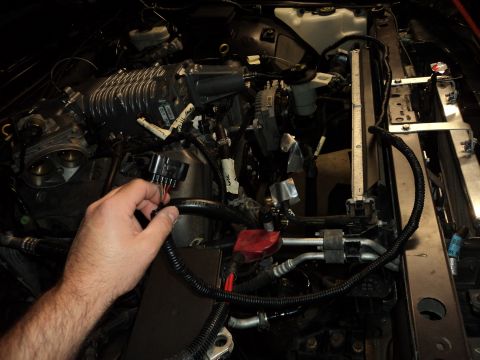 2004 Mercury Grand Marquis - A hand connects wiring to a supercharged engine, likely part of a Marauder Eaton swap. The Supermotors.net logo is visible in the lower rig…