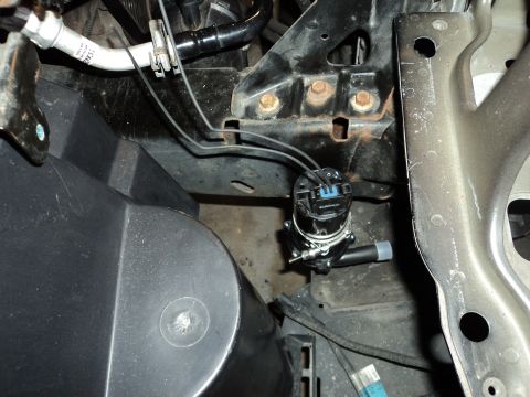 2004 Mercury Grand Marquis - Close-up view of engine bay components, including wiring and a small pump.
