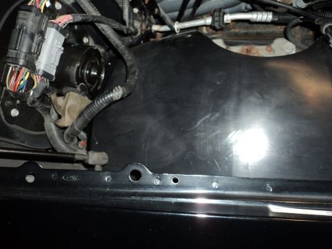 2004 Mercury Grand Marquis - Close-up view of engine bay components including wiring and a black plastic shroud.