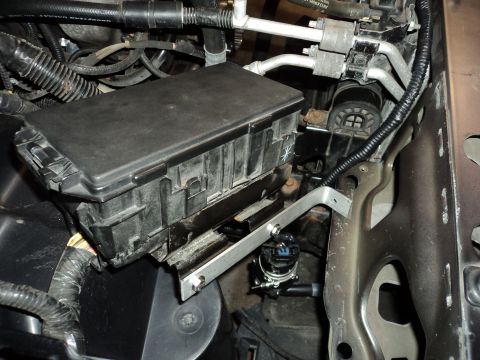 2004 Mercury Grand Marquis - Close-up view of the engine bay, focusing on the fuse box and associated wiring. The SuperMotors logo is visible in the lower right corner.