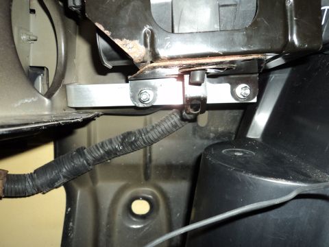 2004 Mercury Grand Marquis - This image shows a close-up view of custom bracketry and a wiring harness, likely within a vehicle's engine compartment.