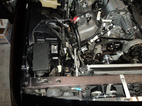 2004 Mercury Grand Marquis - Close-up view of a modified engine bay, showing a supercharger and various engine components.