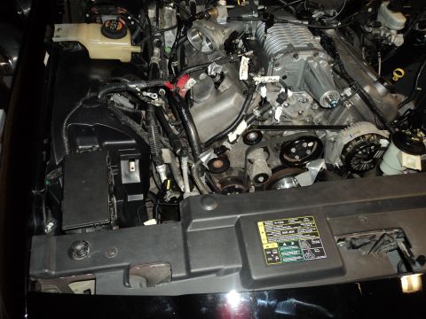 2004 Mercury Grand Marquis - Close-up view of a modified engine bay, highlighting a supercharger and associated components.