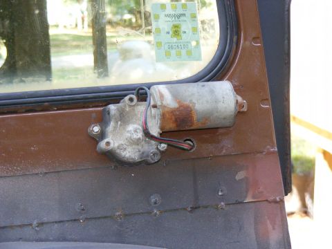 Vehicle door with window motor assembly and Mississippi inspection sticker