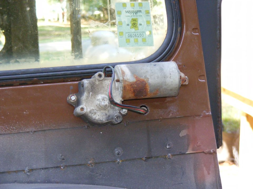 Vehicle door with window motor assembly and Mississippi inspection sticker