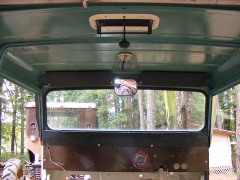 Interior view looking out rear window, with another vehicle visible outside