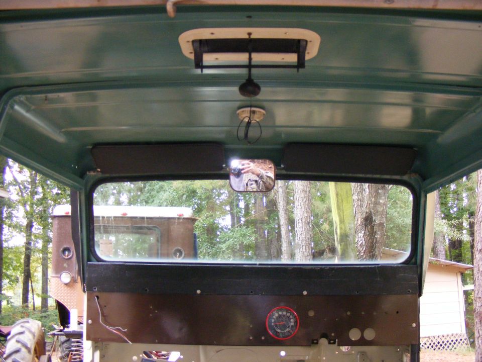 Interior view looking out rear window, with another vehicle visible outside