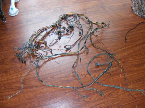 Vehicle wiring harness spread out on a wooden floor