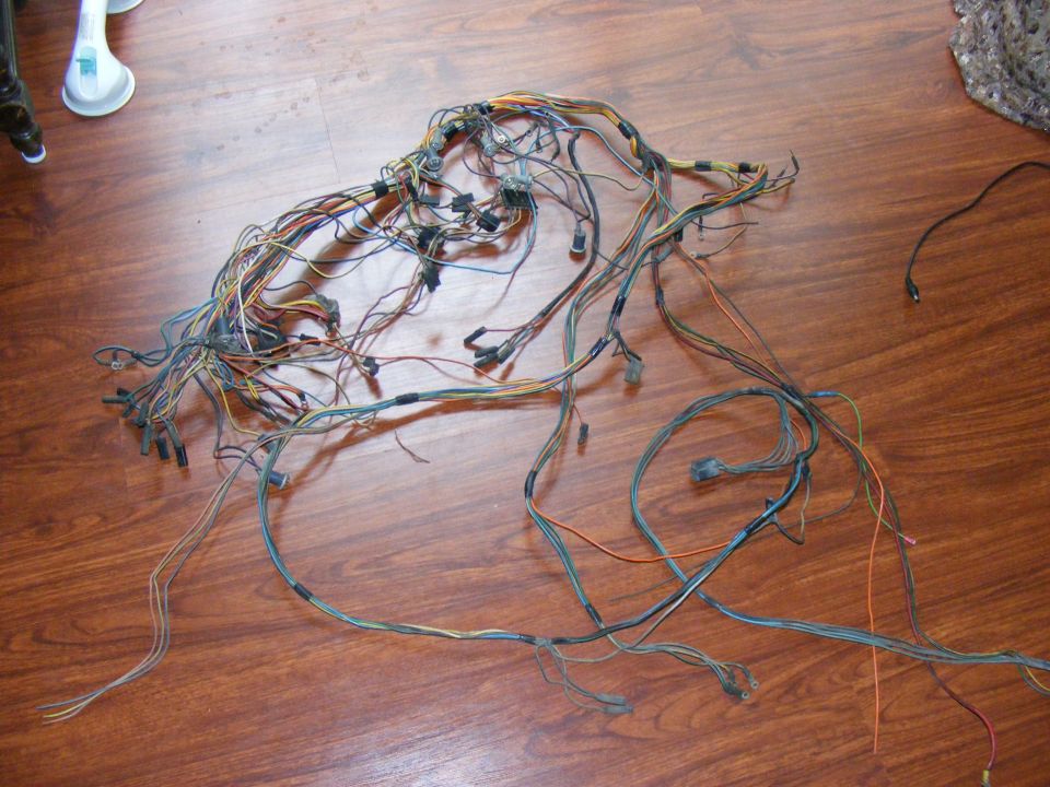 Vehicle wiring harness spread out on a wooden floor