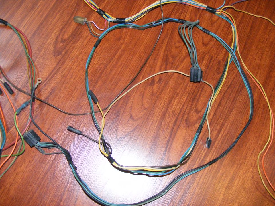 Wiring harness with multiple colored wires and connectors on a wooden surface