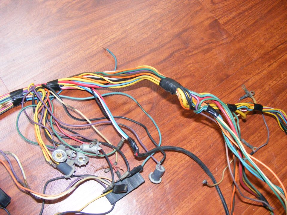 Wiring harness with multiple colored wires and connectors on a wooden surface