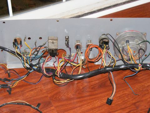 close-up of a vehicle's wiring harness with many colored wires and electrical components