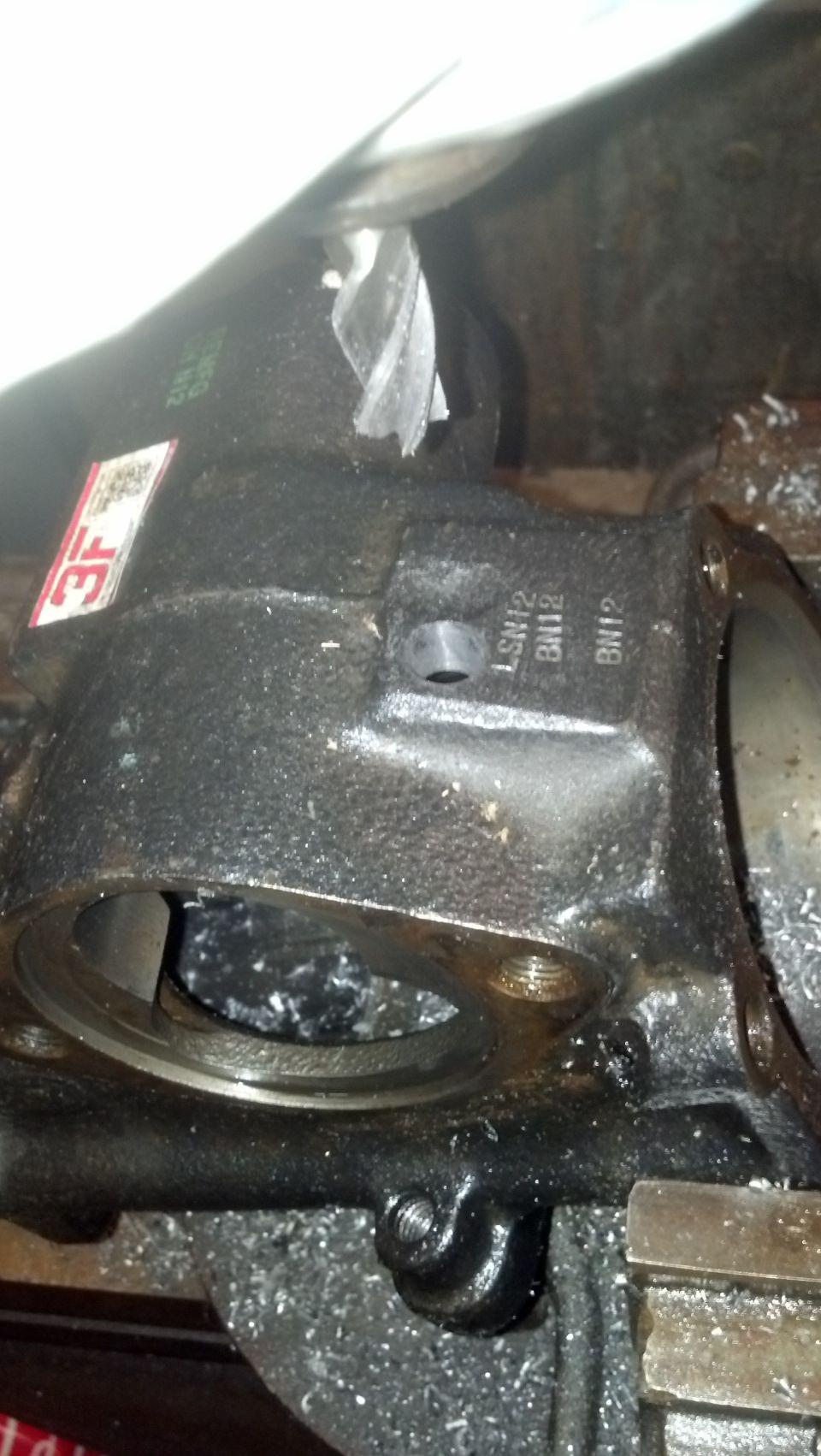 Left hand turn pressure port hole milled into the flat spot .  It is VERY thick here, no worries about tapping too deep.