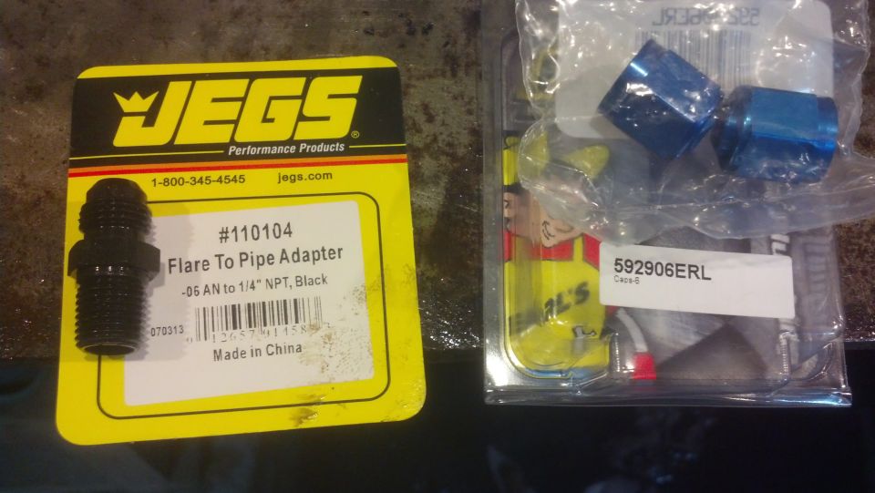 JEGS Flare To Pipe Adapter part #110104 and two blue fittings in packaging