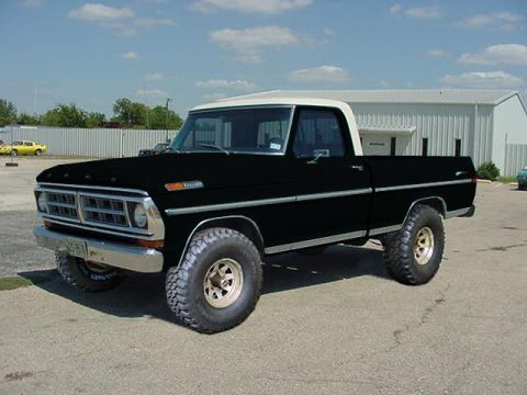 1994 Ford Bronco - This classic Ford pickup truck features a two-tone paint scheme and off-road tires.
