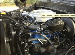 1978 Ford Bronco - Close-up view of the engine compartment in a Ford Bronco, highlighting the V8 engine and associated components.