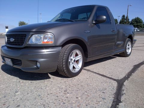 2003 Ford F-150 - Front 3/4 view of a dark gray 2003 Ford F-150 Lightning pickup truck.