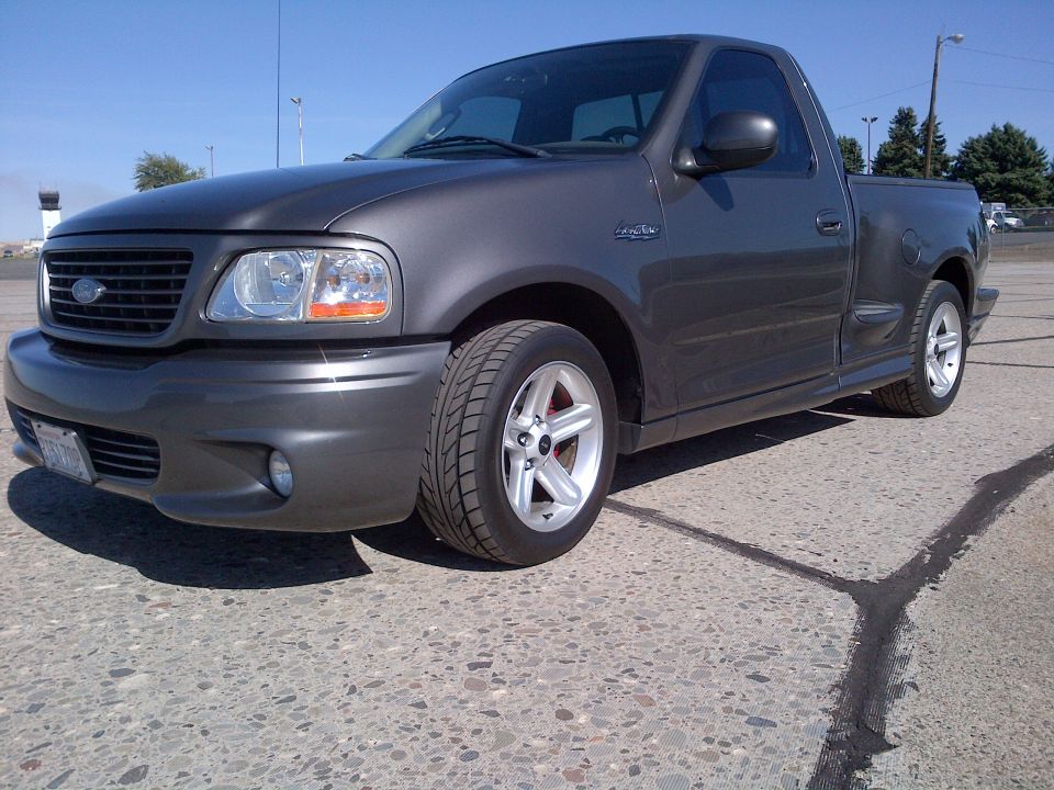 Dark gray 2003 Ford F-150 Lightning pickup truck parked on asphalt
