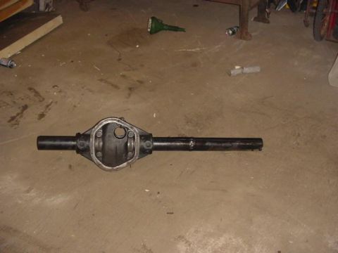 1992 Ford Bronco - A Ford rear axle housing is shown on a concrete floor in a garage.