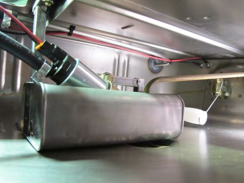 1976 Chevrolet Corvette - Close-up view of a fuel pump and sender assembly installed in a stainless steel tank.