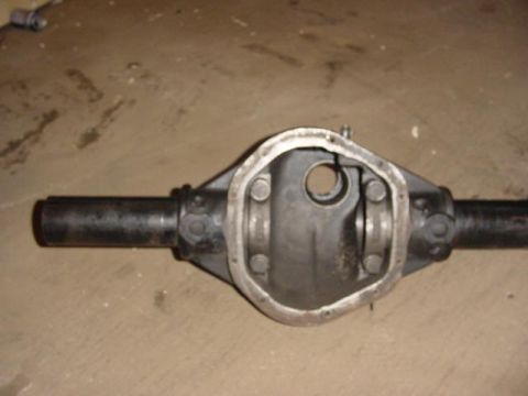 1992 Ford Bronco - This is a close-up view of a differential axle housing, likely a Ford 9-inch, resting on a concrete floor.