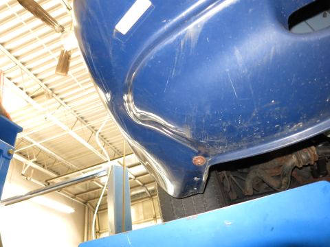 1991 Ford LTD Crown Victoria - The blue car fender shows significant damage and wear.