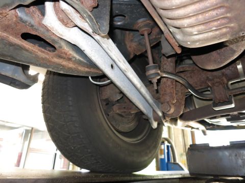 1991 Ford LTD Crown Victoria - Undercarriage view showing suspension components and a tire.