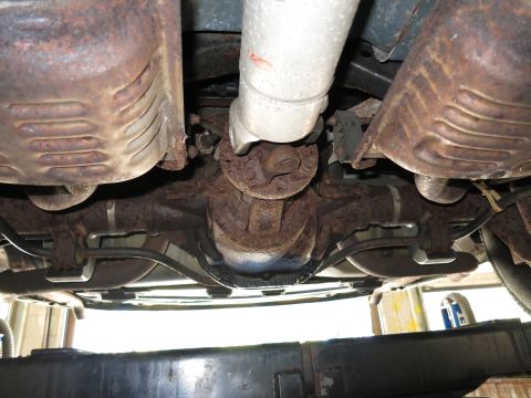 1991 Ford LTD Crown Victoria - Undercarriage view shows exhaust system and rear differential components.