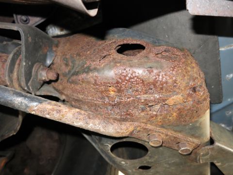 1991 Ford LTD Crown Victoria - This close-up shows severe rust damage on a vehicle's frame, indicating potential structural weakness.