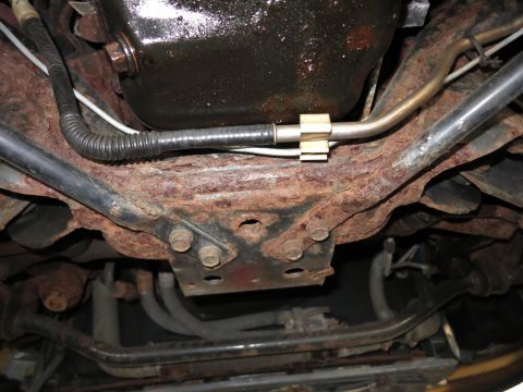 1991 Ford LTD Crown Victoria - Undercarriage view of a vehicle, showing extensive rust on the frame and suspension components.