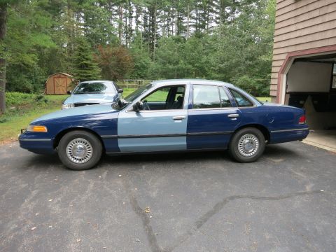 1991 Ford LTD Crown Victoria - This 1991 Ford Crown Victoria LTD has a two-tone paint job and is parked next to a garage.