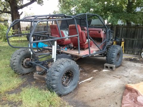 1986 Ford Bronco - This custom buggy is undergoing modifications with a prominent roll cage and oversized tires.