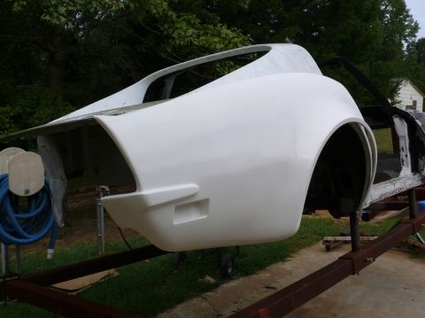 1976 Chevrolet Corvette - The rear body section of a 1976 Chevrolet Corvette, presented in white fiberglass and mounted on a trailer for restoration.