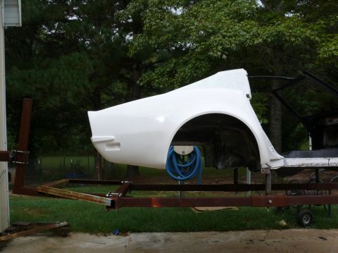 1976 Chevrolet Corvette - Unidentified white car body panel is mounted on a trailer, possibly undergoing restoration.