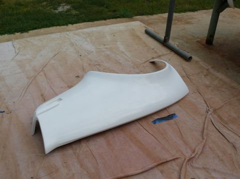 1976 Chevrolet Corvette - A white car fender part is shown on a drop cloth, possibly for repair or replacement.