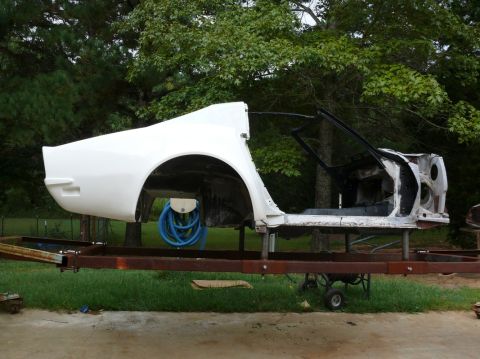 1976 Chevrolet Corvette - The rear quarter panel and wheel well are visible on this car body undergoing restoration.