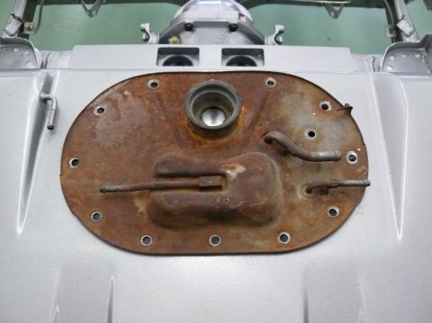 1976 Chevrolet Corvette - A rusty fuel tank sending unit cover is shown from a top-down perspective.
