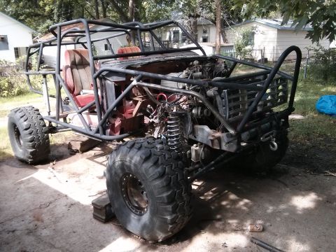 1986 Ford Bronco - This heavily modified vehicle features a custom roll cage and oversized tires, suggesting it's built for off-road use.