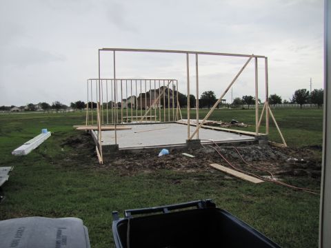 1995 Ford Bronco - House framing is underway on a concrete foundation in a suburban area.
