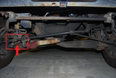 1996 Ford F-150 - A close-up view of a vehicle's undercarriage, highlighting suspension and steering mechanisms.