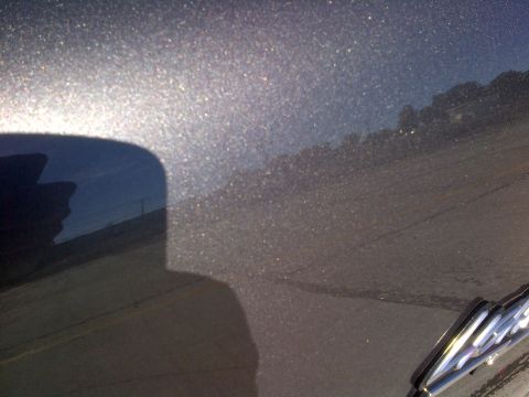 2003 Ford F-150 - Detail of metallic paint finish on a vehicle part, showing reflections.