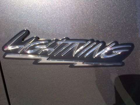 2003 Ford F-150 - A chrome 'Lightning' emblem is shown on a vehicle's exterior.