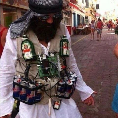 2006 Ford E350 - A person walks down a street wearing a vest with various drinks and electronic components attached.