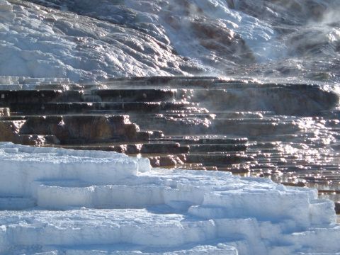 2006 Ford E350 - Travertine terraces in a geothermal area, with steam rising from the mineral formations.